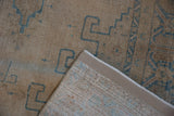 A vintage Persian Veece carpet corner flipped to show the hand-knotted foundation and restored side.
