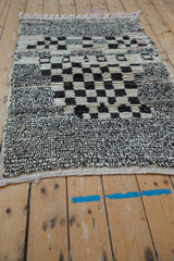Textured vintage Moroccan rug with salt and pepper knotting, checkered pattern, and original side selvage.