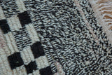 Textured salt and pepper pile of vintage Moroccan rug, with asymmetric checkered design and fringed edge.