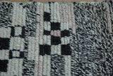 Close-up of vintage Moroccan rug pile: asymmetric ivory and salt-and-pepper dark brown.