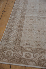 Distressed vintage Hamadan runner detail: serrated leaf border, faded Herati field, antique ivory and beige.