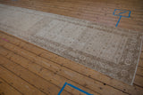 Distressed vintage Hamadan runner with muted ivory Herati field and traditional floral border details.