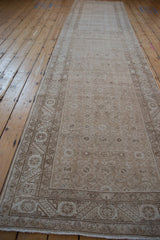 Distressed vintage Hamadan runner close-up showing Herati field and serrated floral borders in antique ivory.
