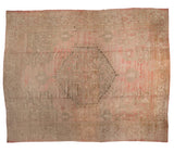 Vintage distressed Oushak carpet with a geometric medallion in faded rose, silver, and beige tones.