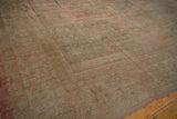 Angled view across the soft, lustrous pile of a distressed vintage Oushak carpet.