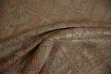 Close-up on the soft, lustrous texture of a distressed Oushak carpet's varied pile.