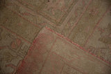 Corner of a vintage Oushak showing the hand-knotted foundation and soft, low pile.