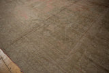 The varied pile and high luster on a distressed Oushak carpet's geometric border.
