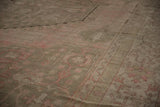 Soft, lustrous pile of a vintage Oushak carpet with time-softened rose and silver geometric details.