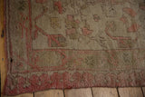 Intact side cord selvage and soft, low pile texture on a distressed vintage Oushak carpet.
