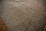 Polished sheen on the soft, distressed pile of a vintage Oushak carpet.