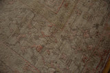 Soft, hand-knotted pile with varied height showing the distressed texture of a vintage Oushak.