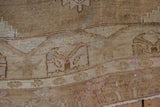 Distressed Kars carpet pile, showing worn texture, primitive relief, and soft pink details.