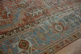 Textured distressed Mehrivan carpet detail: geometric vines and Samovar Turtle border in terracotta, dusty blue.