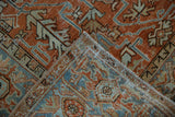Distressed Mehrivan rug pile in terracotta and sky blue geometric motifs, showing foundation and fringe.