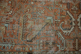 Geometric vines and scrolled leaves with distressed texture on pale terracotta Mehrivan carpet.