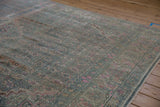 A long angle view displays the even, distressed wear on this vintage Persian Bijar carpet.