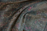 Soft, draped folds of a vintage Bijar show its even wear and muted pink motifs.