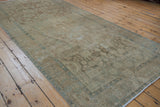 Faded floral and geometric motifs on a distressed vintage Malayer runner.