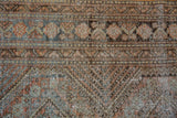 Distressed West Persian carpet texture with faded terracotta, dusty teal, brown, and exposed foundation.