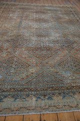 Worn Malayer border with faded copper, dusty teal, and chocolate brown tones, showing foundation.