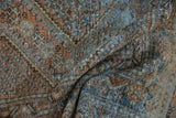 Distressed West Persian carpet showing storied texture, visible foundation, terracotta and teal tones.