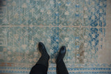 Decorative wear and low-pile texture of a vintage Hamadan rug in dusty blue and teal.