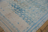 Geometric field and meandering floral vine border on a distressed vintage Hamadan rug.