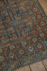 Distressed vintage Afghani Belouch rug, chestnut and dusty blue geometric gul motifs, showing wear.