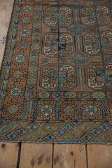Worn Belouch design end border with geometric diamonds in dusty blue, olive, and chestnut.
