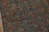 Distressed Afghani Belouch rug's geometric gul patterns in chestnut, dusty blue, and olive green.