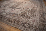 Distressed Persian Khoy rug showing muted dusty mauve, brown, ivory floral motifs and detailed border.