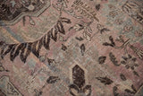 Distressed Khoy carpet pile showing dusty mauve and charcoal brown floral motifs.