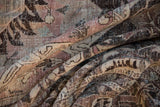 Distressed Khoy carpet folds, showcasing textured pile in dusty mauve, charcoal, and ivory.