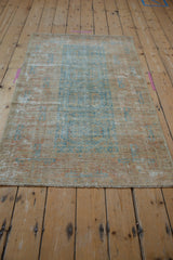 Distressed Afghani Belouch rug's secured end, with mostly even wear and original cord selvage.