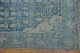 Distressed Hamadan runner corner featuring worn blue boteh pattern and faded neutral borders.
