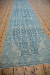 Distressed Hamadan runner's powder blue boteh pattern, border, and intact side selvage.