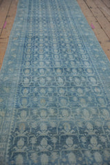 Repeating blue boteh pattern on a distressed vintage Hamadan rug runner.