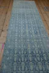 Decorative distressed blue and ivory boteh pattern on the vintage Hamadan rug runner.