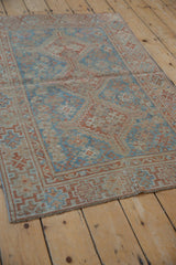 Distressed vintage Shiraz rug with worn sky blue and chestnut geometric field patterns.