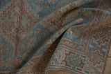 Textured distressed pile with geometric patterns in sky blue, chestnut, and terracotta.