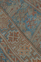 Distressed Shiraz rug with foundation wear, seam, and blue, rust geometric patterns.