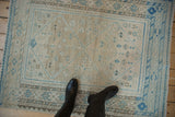 Distressed Afshar rug, faded geometric diamond motifs in soft blue and silver tones.