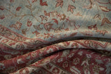 Folded vintage distressed Mahal carpet section with wine burgundy border and dusty blue vinery.