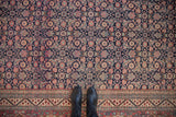 Classic Samovar turtle border and navy Herati field on vintage Tabriz carpet.