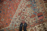 Rich abrashes across powder blue and madder red fields of an antique geometric Bakshaish carpet.