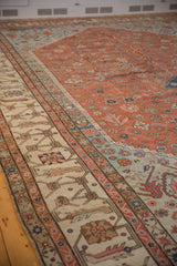 The intricate, primitive border designs and even wear of a collectible antique Bakshaish carpet.