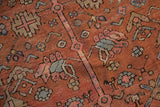 Primitive floral motifs on the time-softened madder red pile of a collector's antique Bakshaish carpet.