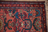 Blush Mehreban rug field: large scale floral blossoms, vines in blue, red, and green.