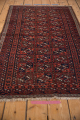 Vintage Belouch rug with paneled guls, wine red, navy, brown, and mostly even wear.